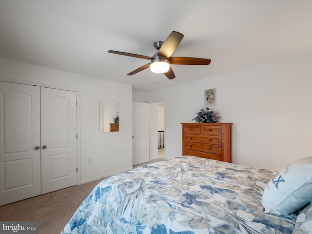 carpeted bedroom with a closet, a ceiling fan, and baseboards