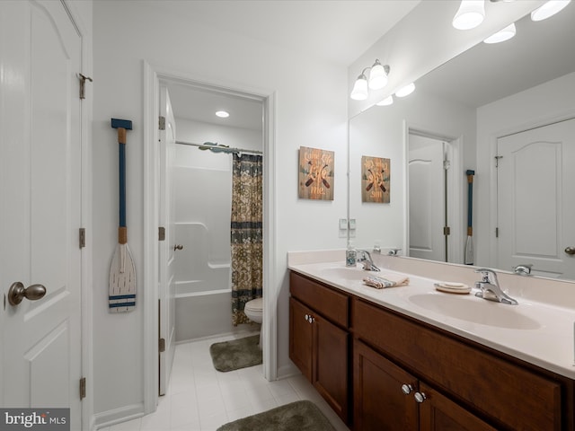 bathroom featuring double vanity, shower / tub combo, toilet, and a sink