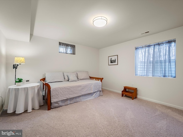 bedroom featuring multiple windows, carpet, visible vents, and baseboards