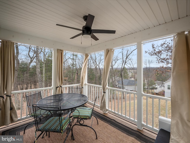 sunroom with a ceiling fan