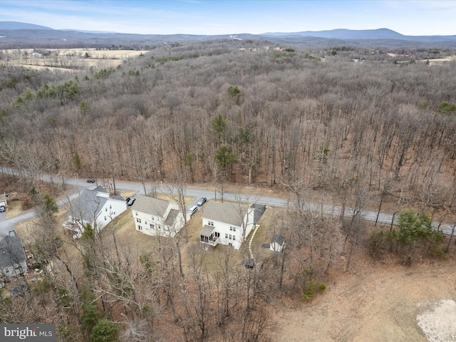 aerial view with a mountain view and a wooded view