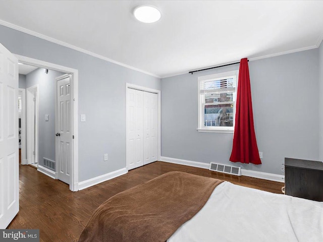 bedroom with visible vents, baseboards, and wood finished floors