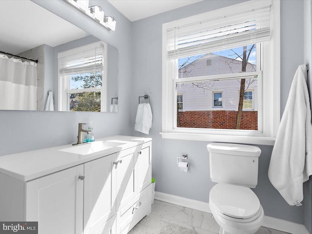 full bath featuring marble finish floor, vanity, toilet, and baseboards