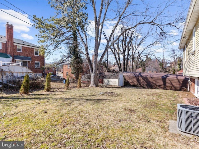 view of yard featuring fence and central AC unit