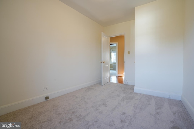 empty room with carpet flooring and baseboards