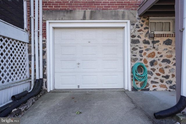 garage featuring concrete driveway