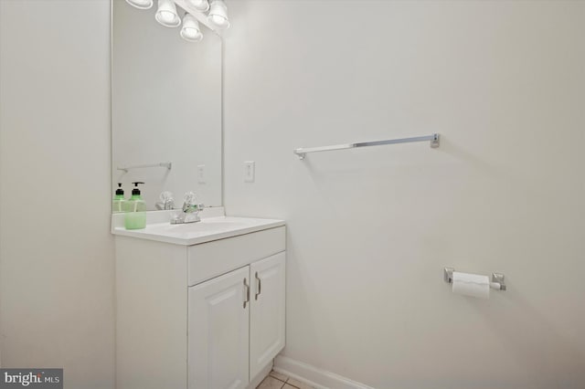 bathroom with tile patterned flooring, vanity, and baseboards