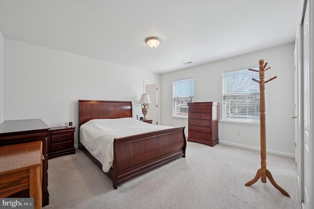 bedroom with carpet floors, visible vents, and baseboards