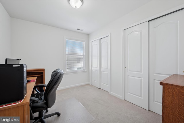 carpeted home office featuring baseboards and visible vents