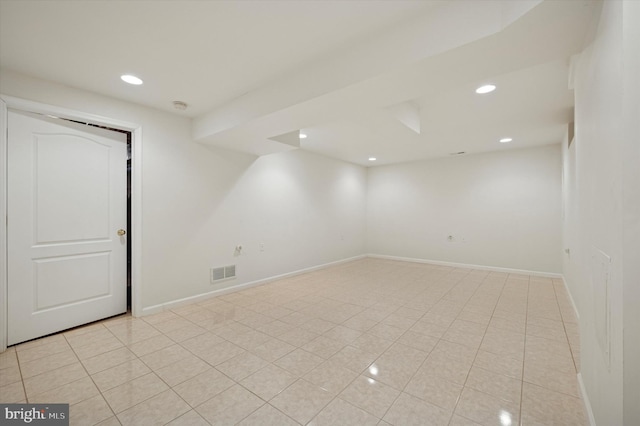 finished basement featuring recessed lighting, visible vents, baseboards, and light tile patterned flooring