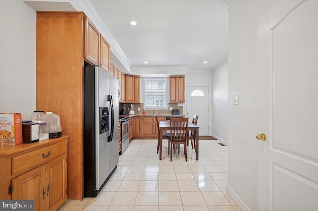 kitchen featuring light tile patterned floors, recessed lighting, appliances with stainless steel finishes, brown cabinetry, and ornamental molding