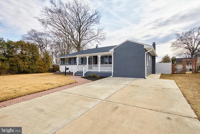 single story home featuring a porch, concrete driveway, stucco siding, a front lawn, and a chimney