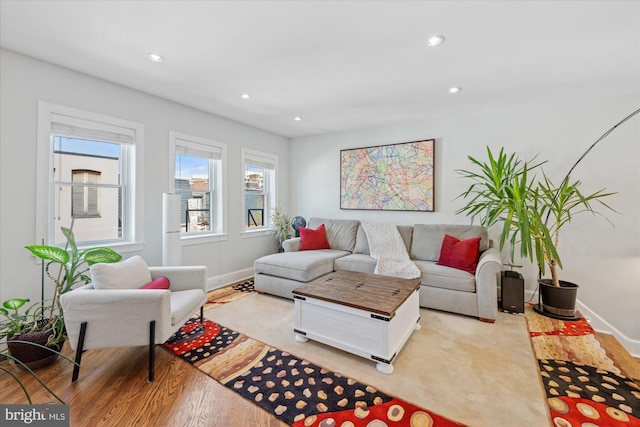 living area with recessed lighting, baseboards, and light wood-style floors