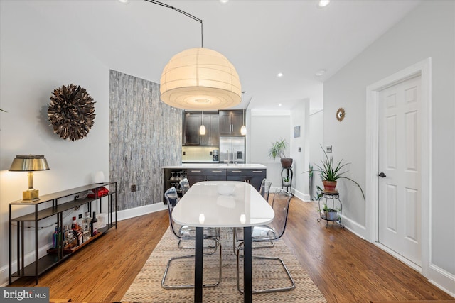 dining area featuring recessed lighting, baseboards, and wood finished floors