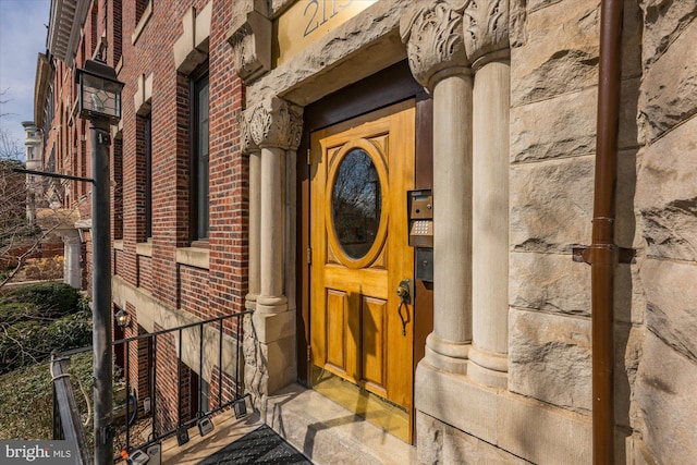 doorway to property with brick siding