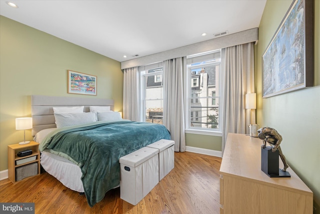 bedroom with light wood-style flooring, recessed lighting, visible vents, and baseboards