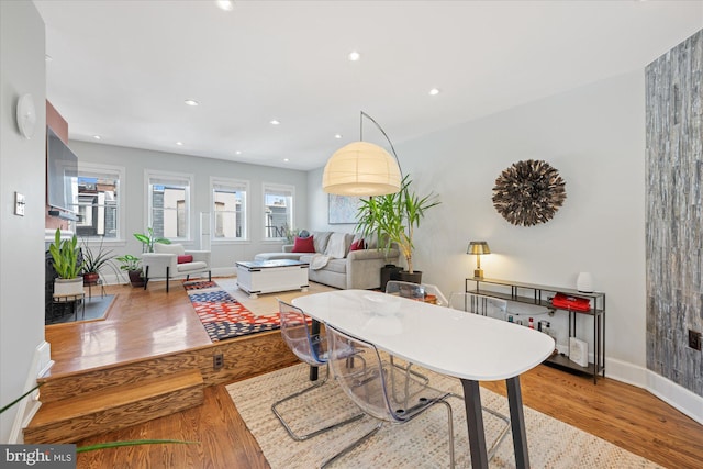 dining room featuring recessed lighting, wood finished floors, and baseboards