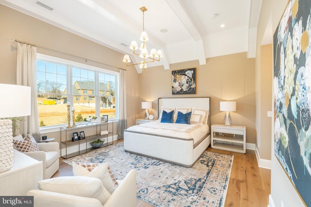 bedroom with beam ceiling, visible vents, wood finished floors, a chandelier, and baseboards