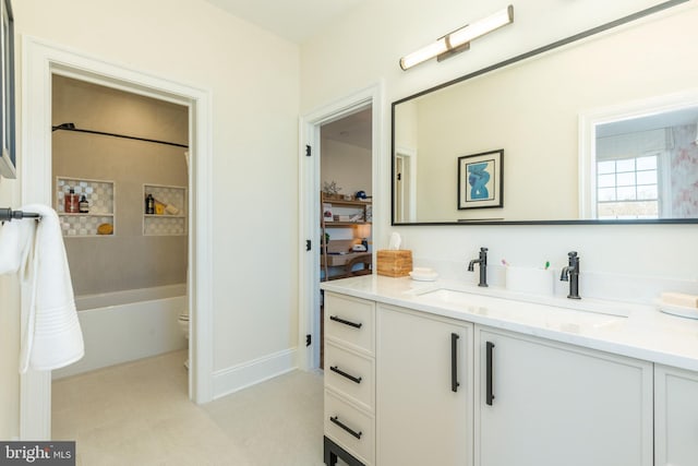 bathroom featuring shower / bathtub combination, baseboards, and vanity