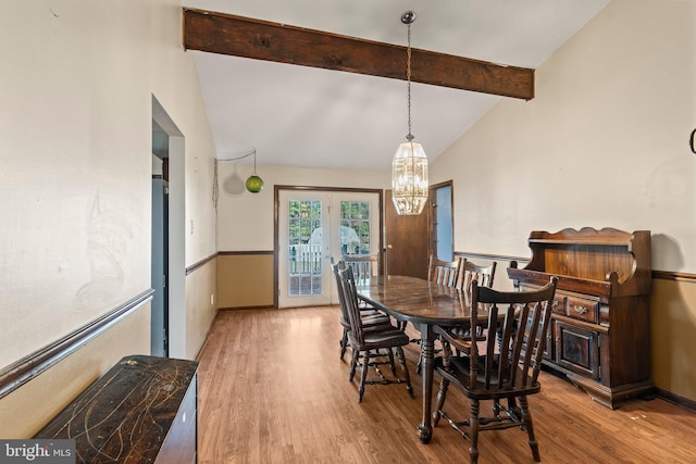 dining space featuring high vaulted ceiling, french doors, wood finished floors, and beam ceiling