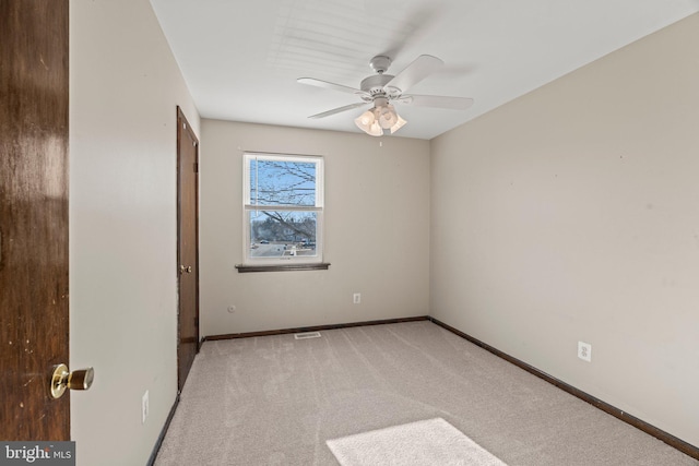 unfurnished bedroom with a ceiling fan, light carpet, visible vents, and baseboards