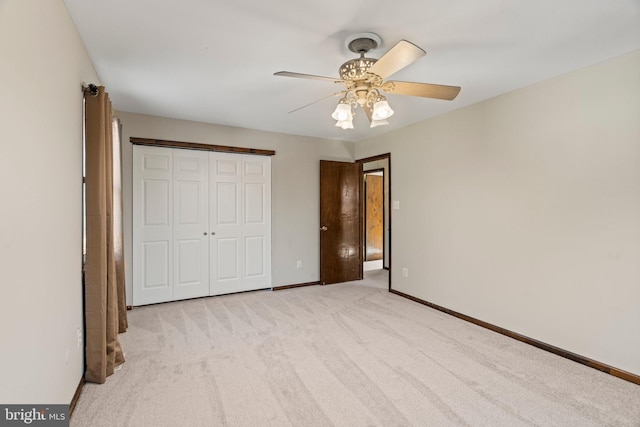 unfurnished bedroom featuring ceiling fan, a closet, carpet flooring, and baseboards