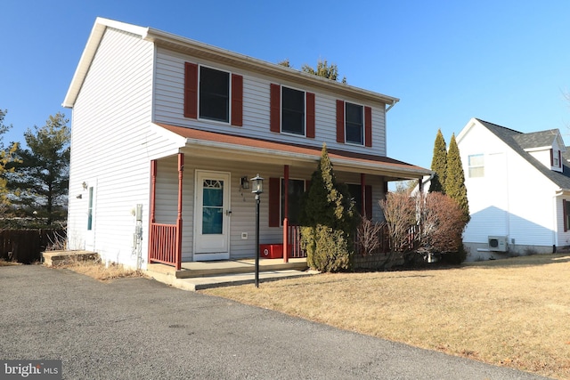 view of front of house with a porch and a front yard