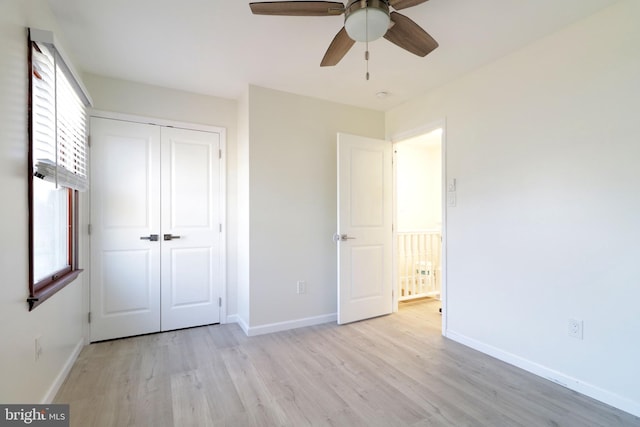 246 First Ave, State College, PA 16801 - unfurnished bedroom with baseboards, a closet, a ceiling fan, and light wood-style floors
