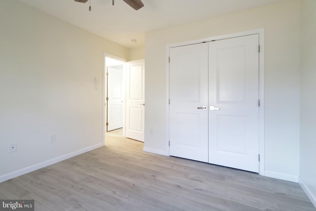 246 First Ave, State College, PA 16801 - unfurnished bedroom featuring a ceiling fan, a closet, light wood-style flooring, and baseboards