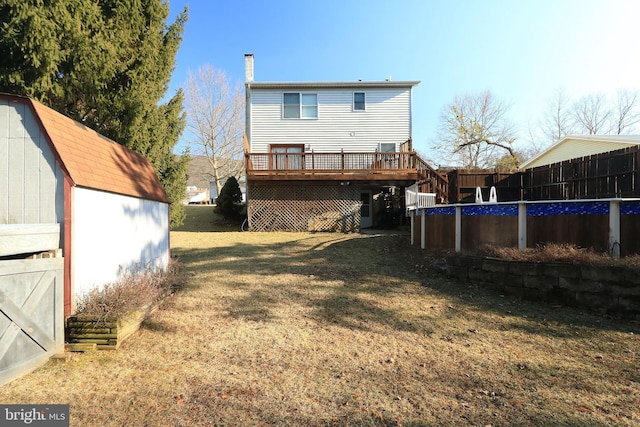 246 First Ave, State College, PA 16801 - back of house featuring a deck, an outdoor structure, fence, a shed, and a chimney