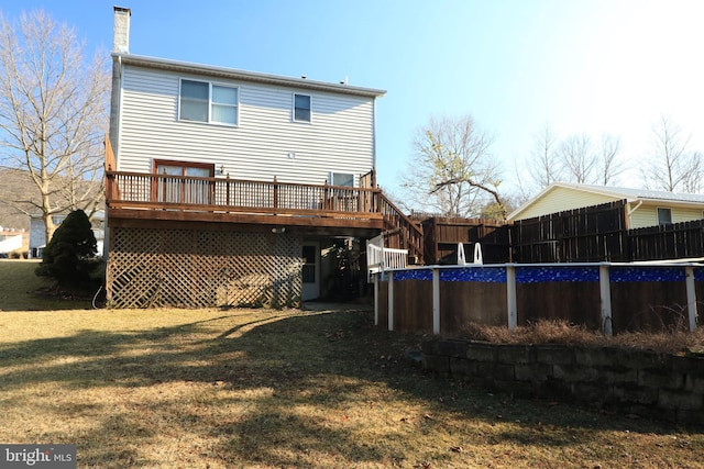 246 First Ave, State College, PA 16801 - back of house with a fenced in pool, a chimney, a lawn, fence, and a deck