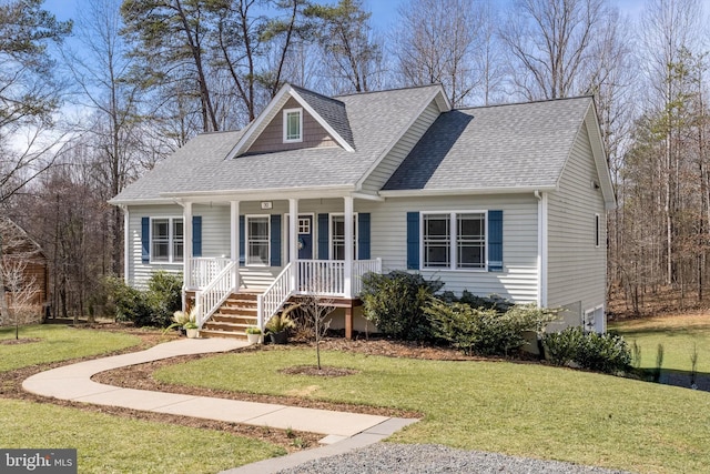 view of front of house featuring roof with shingles, a porch, and a front lawn