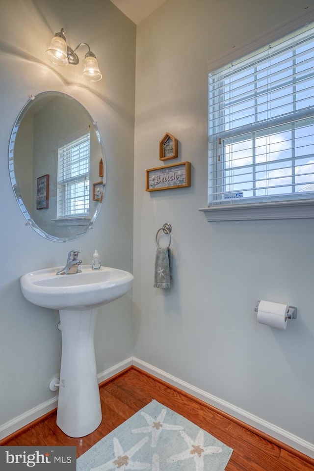 bathroom featuring wood finished floors and baseboards