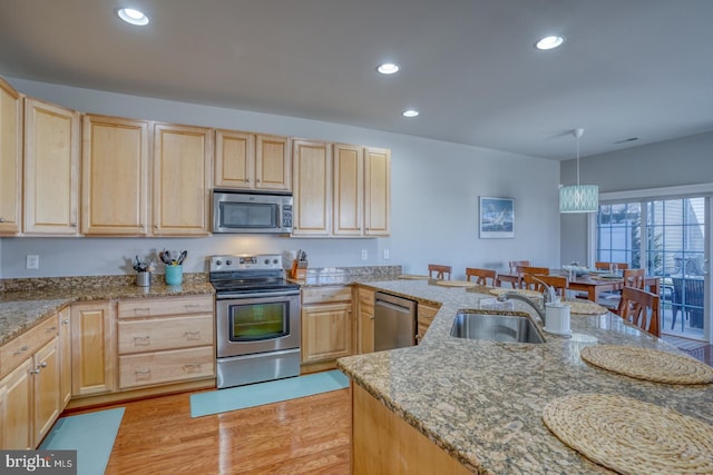 kitchen featuring appliances with stainless steel finishes, recessed lighting, a sink, and light brown cabinetry