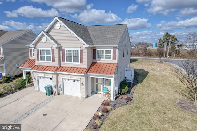 view of front of house with a shingled roof, a standing seam roof, metal roof, a garage, and driveway