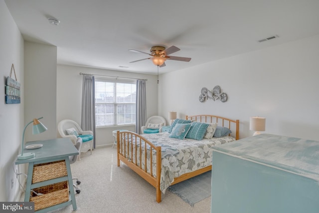 carpeted bedroom with visible vents, ceiling fan, and baseboards