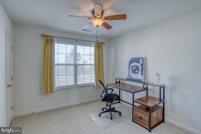 carpeted office space with baseboards, visible vents, and ceiling fan