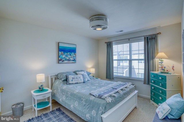 bedroom featuring carpet floors, visible vents, and baseboards