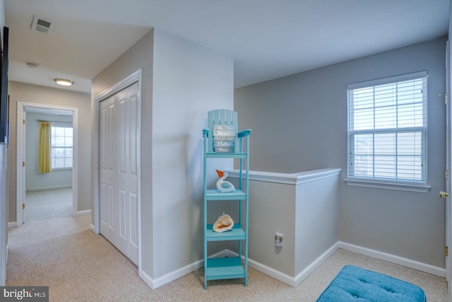 interior space with carpet flooring, visible vents, and baseboards