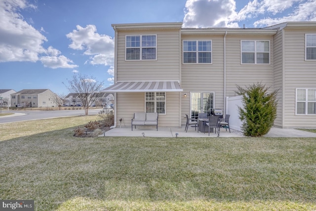 back of house featuring metal roof, a patio, a yard, and fence