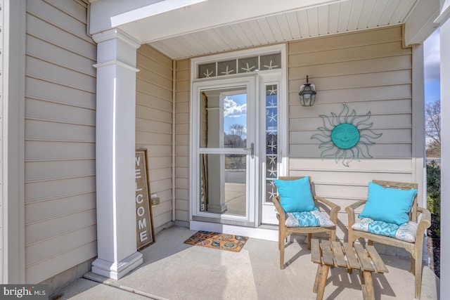 view of exterior entry featuring covered porch