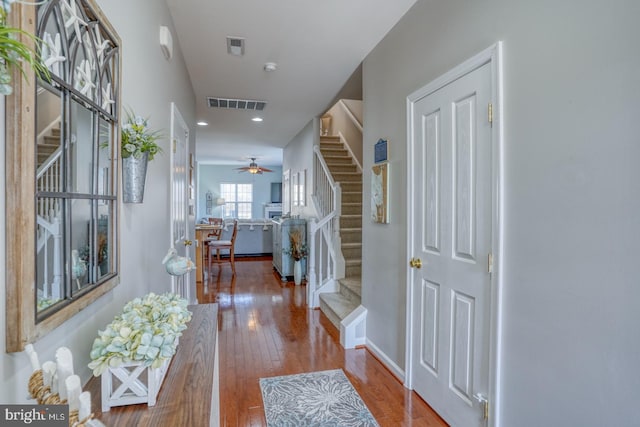 foyer entrance with stairs, wood-type flooring, visible vents, and recessed lighting