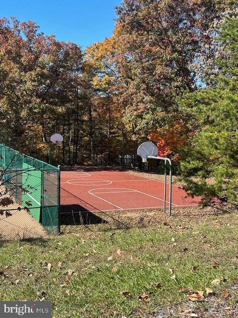 view of basketball court featuring community basketball court and fence