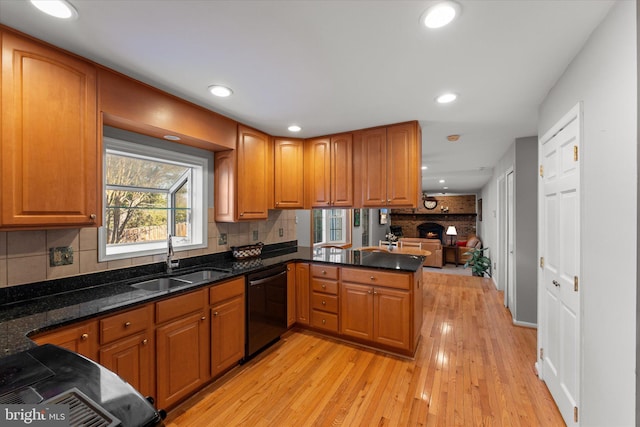 kitchen with brown cabinets, dishwasher, and a sink