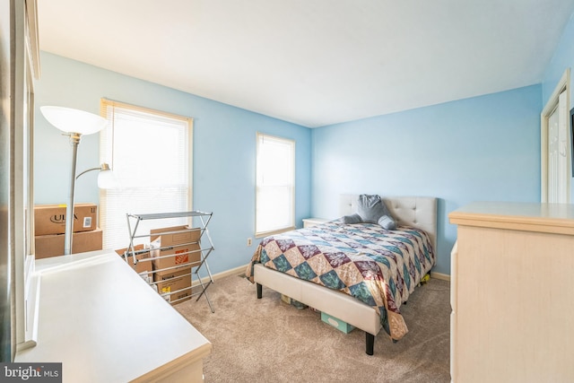 carpeted bedroom with baseboards