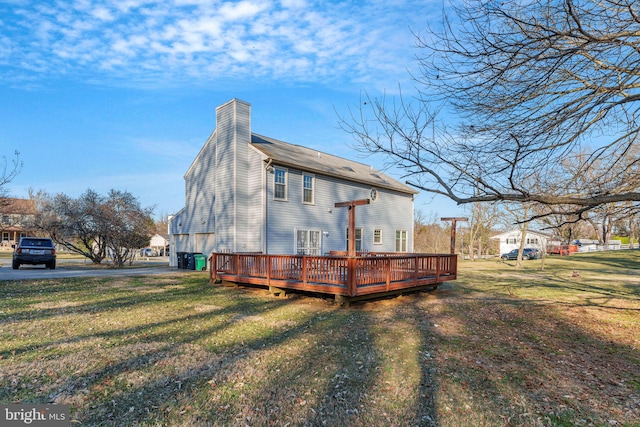 view of property exterior featuring a deck, a lawn, and a chimney