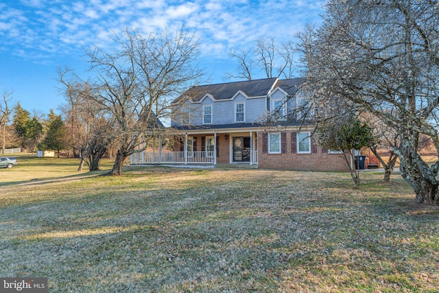 view of front of property featuring brick siding, a porch, and a front lawn