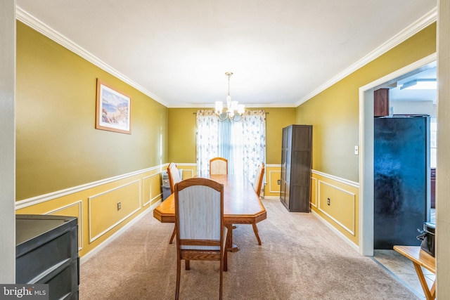 carpeted dining space featuring an inviting chandelier, a decorative wall, crown molding, and wainscoting