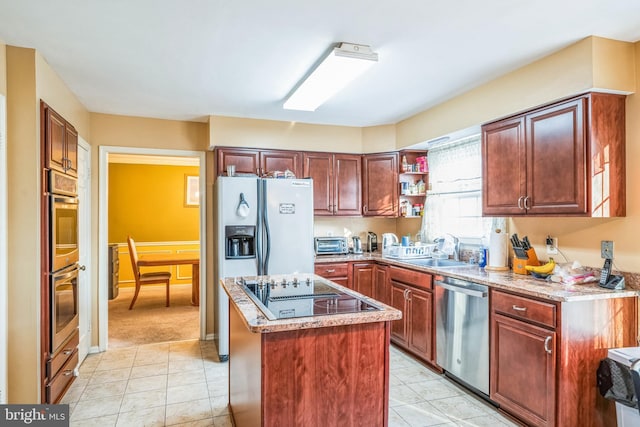 kitchen with light stone countertops, a kitchen island, open shelves, a sink, and appliances with stainless steel finishes