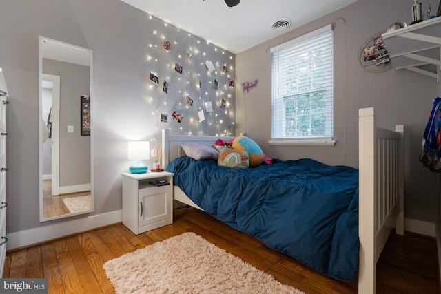 bedroom featuring light wood-type flooring, baseboards, and visible vents